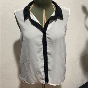Sheer white sleeveless blouse with black trim.